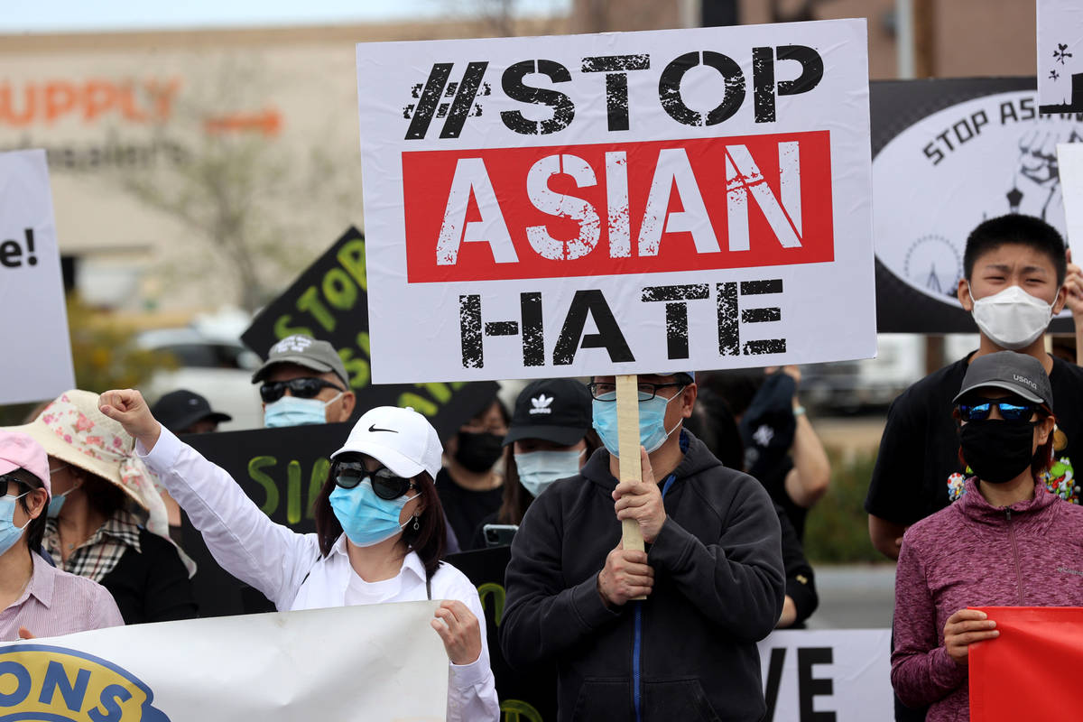 People, including Quinci Luong, left, and Tom Li, rally at a "Stop Asian Hate" event ...