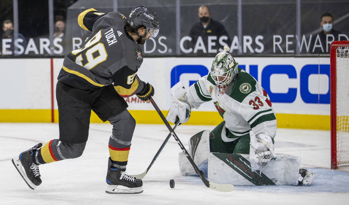 Golden Knights right wing Alex Tuch (89) shoots on Minnesota Wild goaltender Cam Talbot (33) du ...