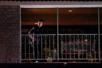 A police officer surveys the scene after a shooting at an office building in Orange, Calif., We ...