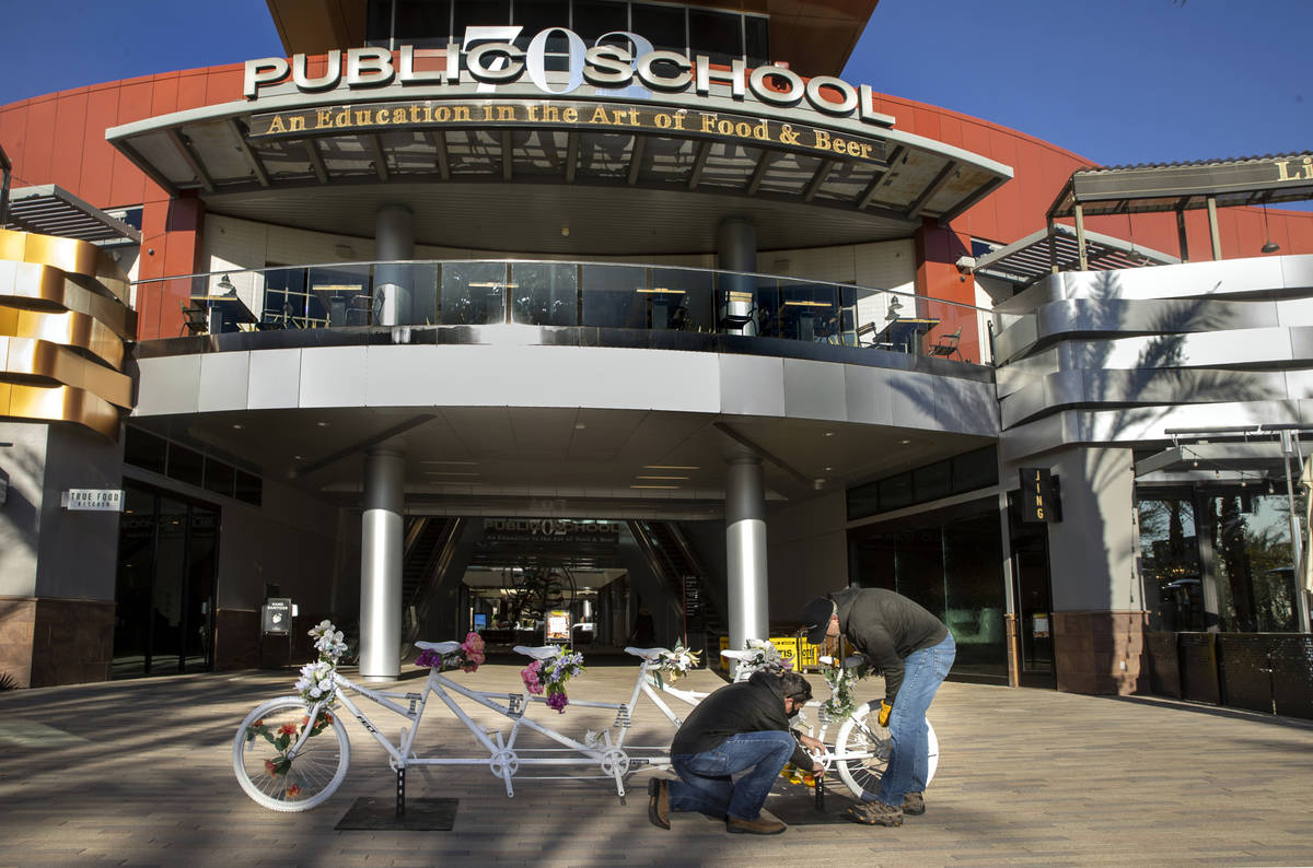 Pat Treichel, left, and Steve White with Ghost Bikes Las Vegas relocate their 5-person bike to ...