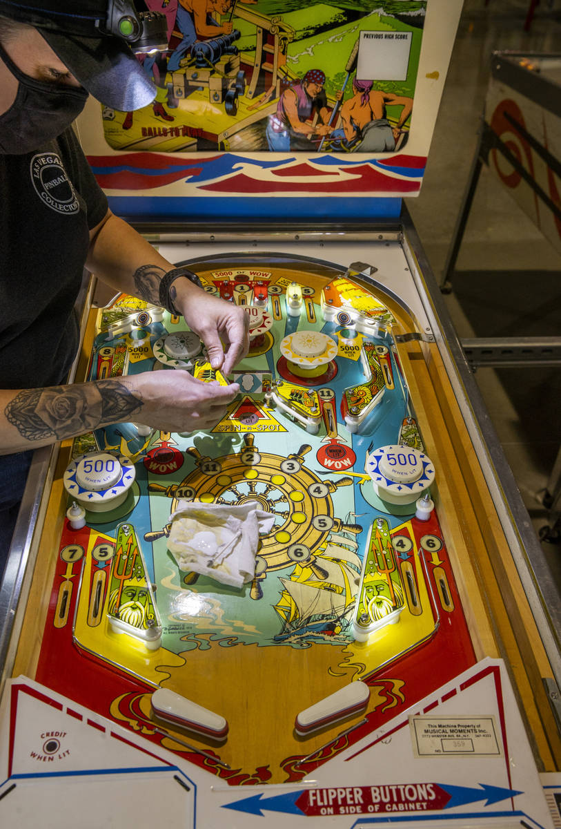 Technician Jennifer Ogilvie repairs a machine at the new Pinball Hall of Fame now located acros ...