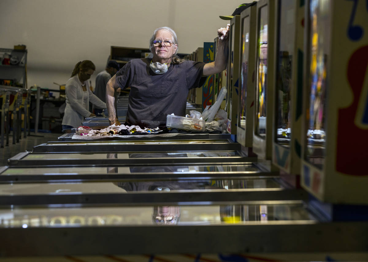 Pinball Hall of Fame owner Tim Arnold repairs his machines at the new location, which opened la ...
