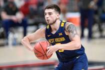 West Virginia's Jordan McCabe (5) passes the ball during the first half of an NCAA college bask ...