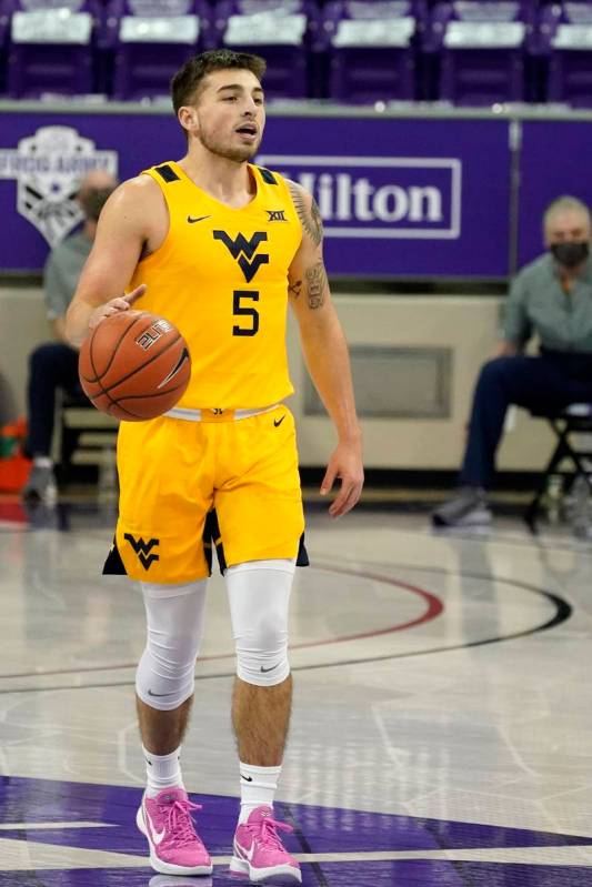 West Virginia guard Jordan McCabe handles the ball during an NCAA college basketball game again ...