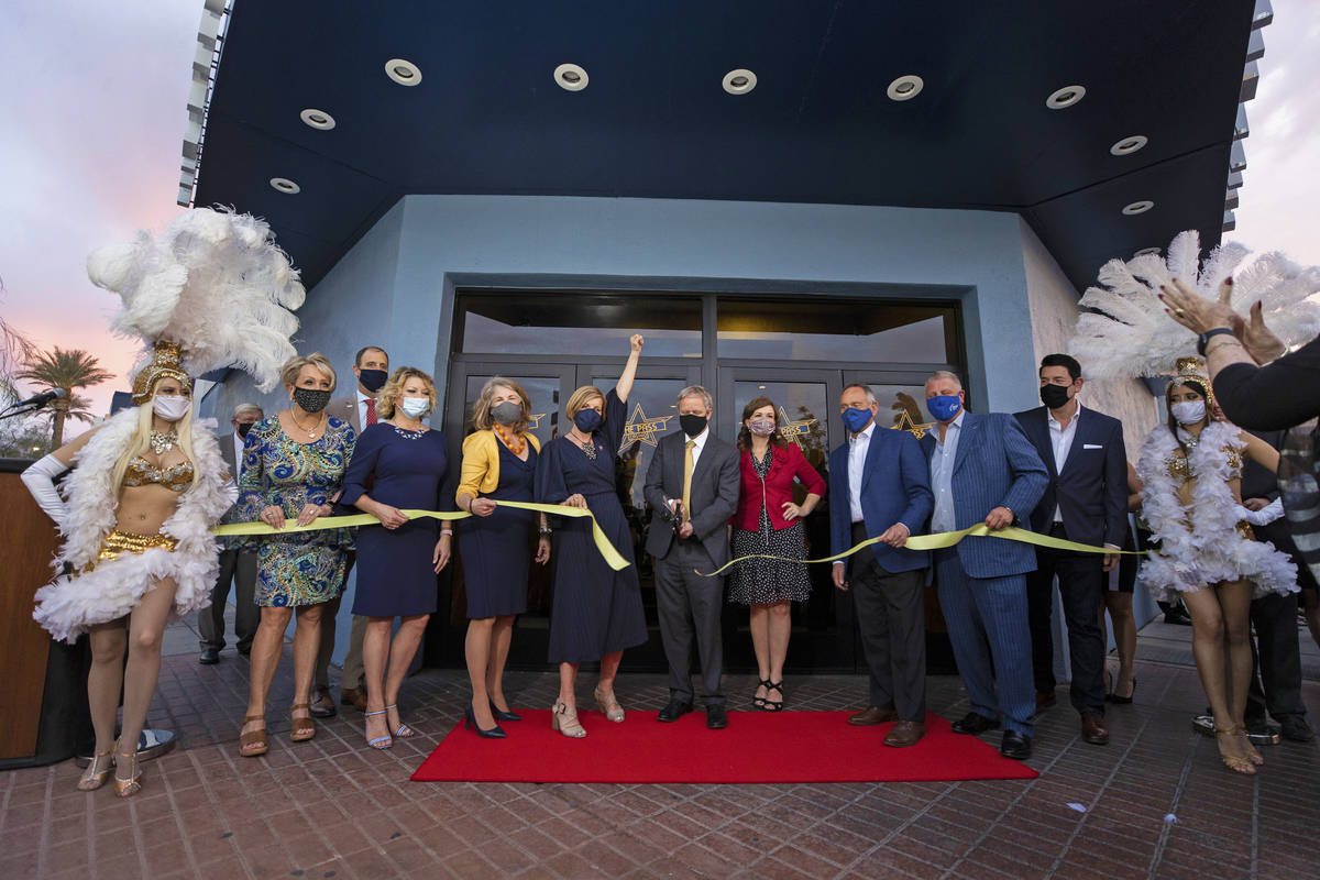 The Pass casino owner Joseph DeSimone, middle, cuts the ceremonial ribbon during opening night ...