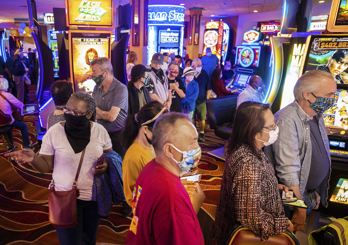 Crowds flood into The Pass casino during opening night in Henderson on Thursday, April 1, 2021. ...