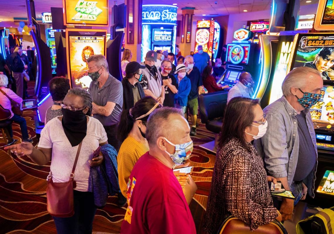 Crowds flood into The Pass casino during opening night in Henderson on Thursday, April 1, 2021. ...