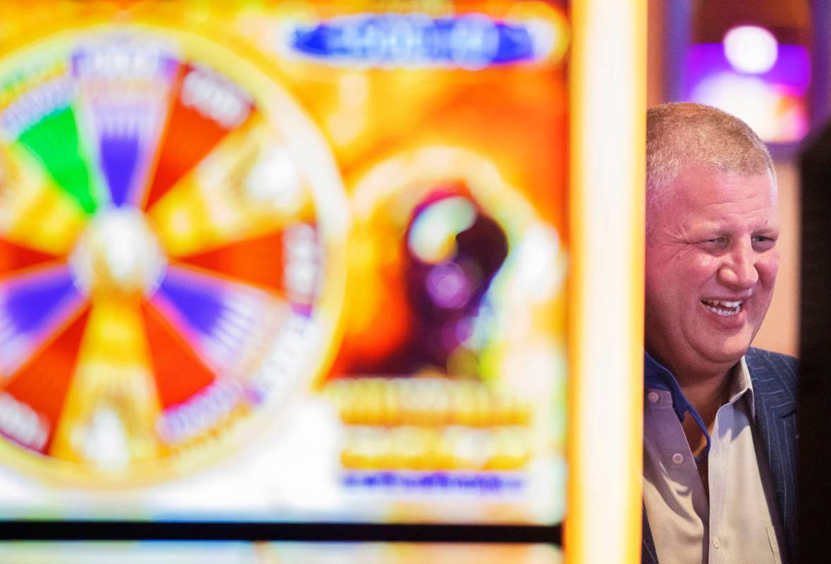 Circa casino owner Derek Stevens shares a laugh with friends during the VIP opening party for T ...