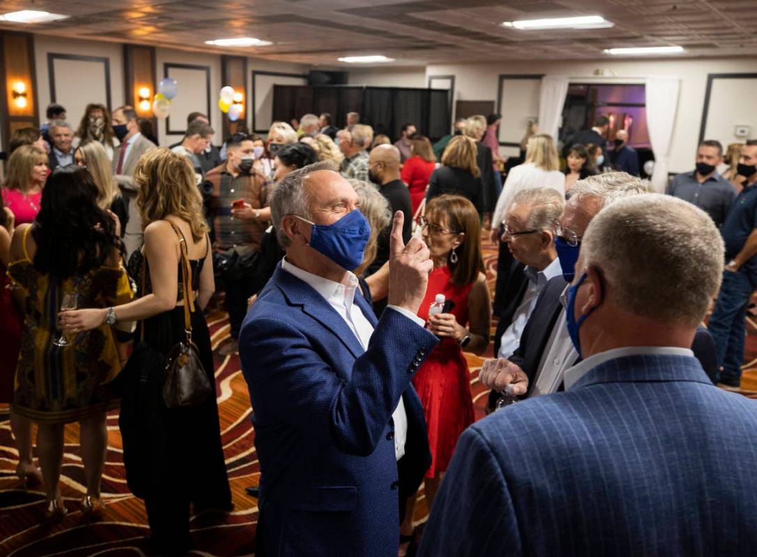 County Commissioner Jim Gibson, middle, speaks with Circa casino owner Derek Stevens during the ...