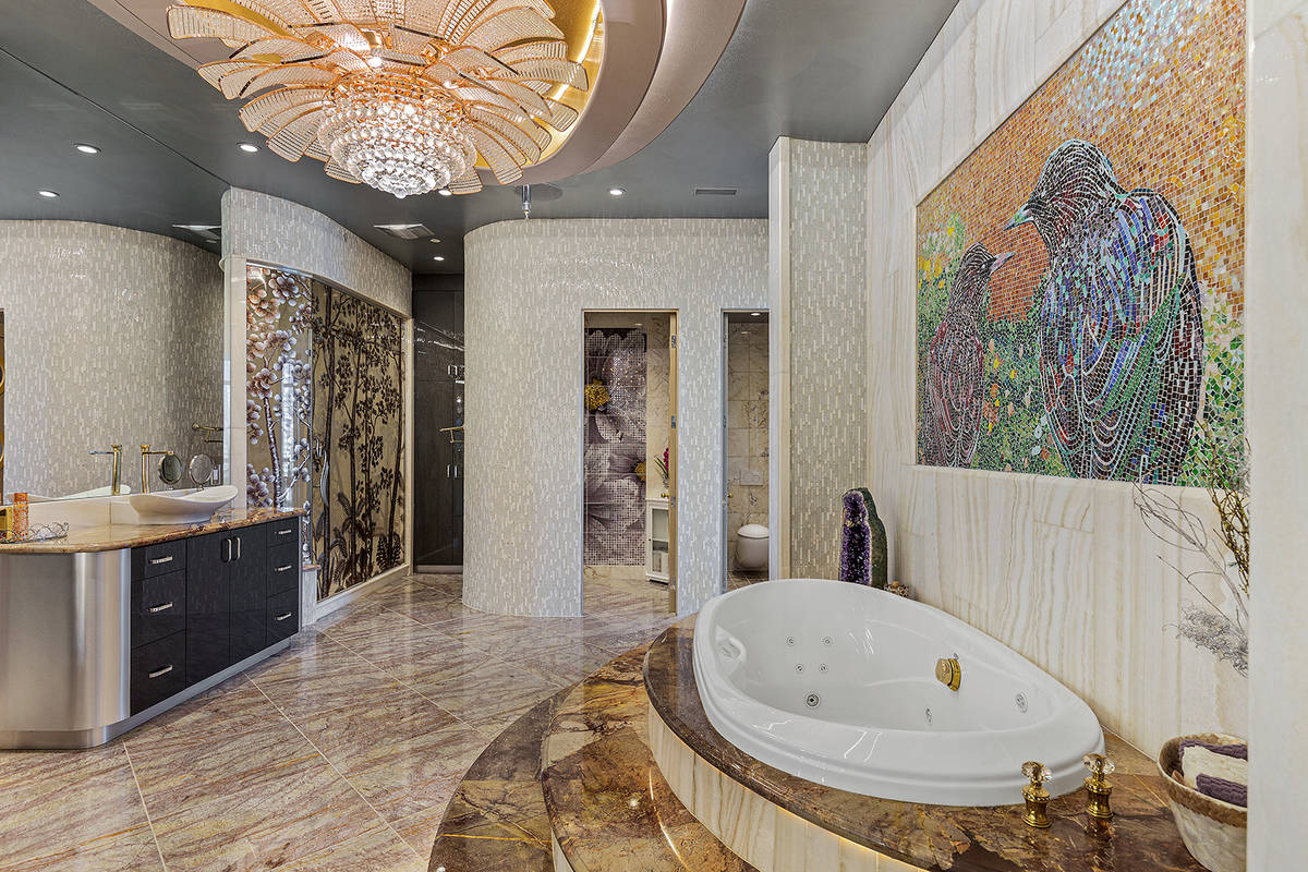 The master bath features an oversized multi-jet, double-bench marble shower with 3D etched-glas ...