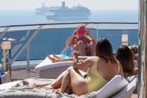 Passengers take selfies on a deck of the MSC Grandiosa cruise ship in Civitavecchia, near Rome, ...