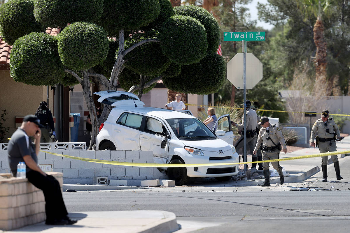 Las Vegas police investigate at the scene of a three-vehicle crash on Twain Avenue near Jones B ...