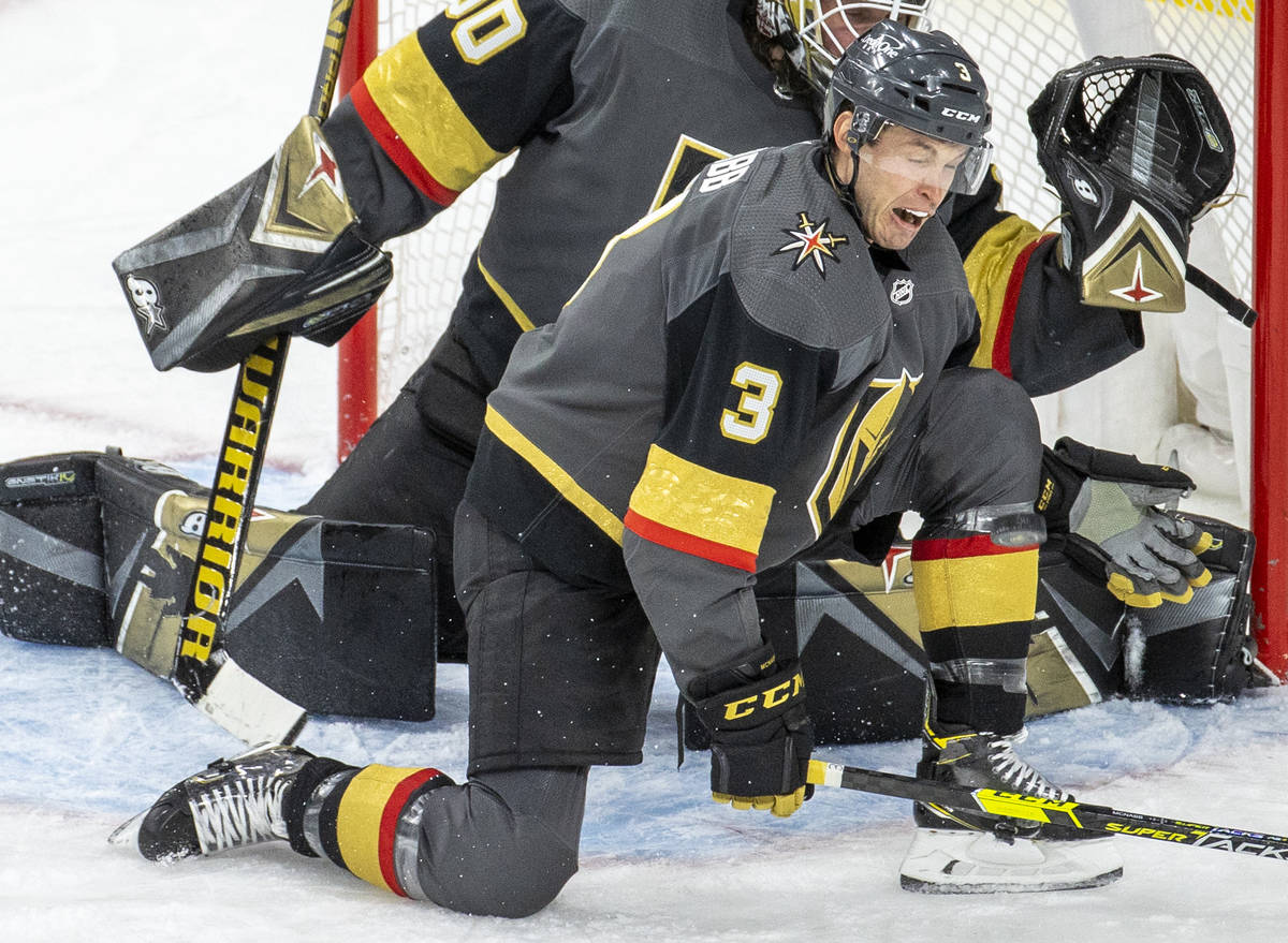 Golden Knights defenseman Brayden McNabb (3) takes a puck to the shin while defending the net w ...
