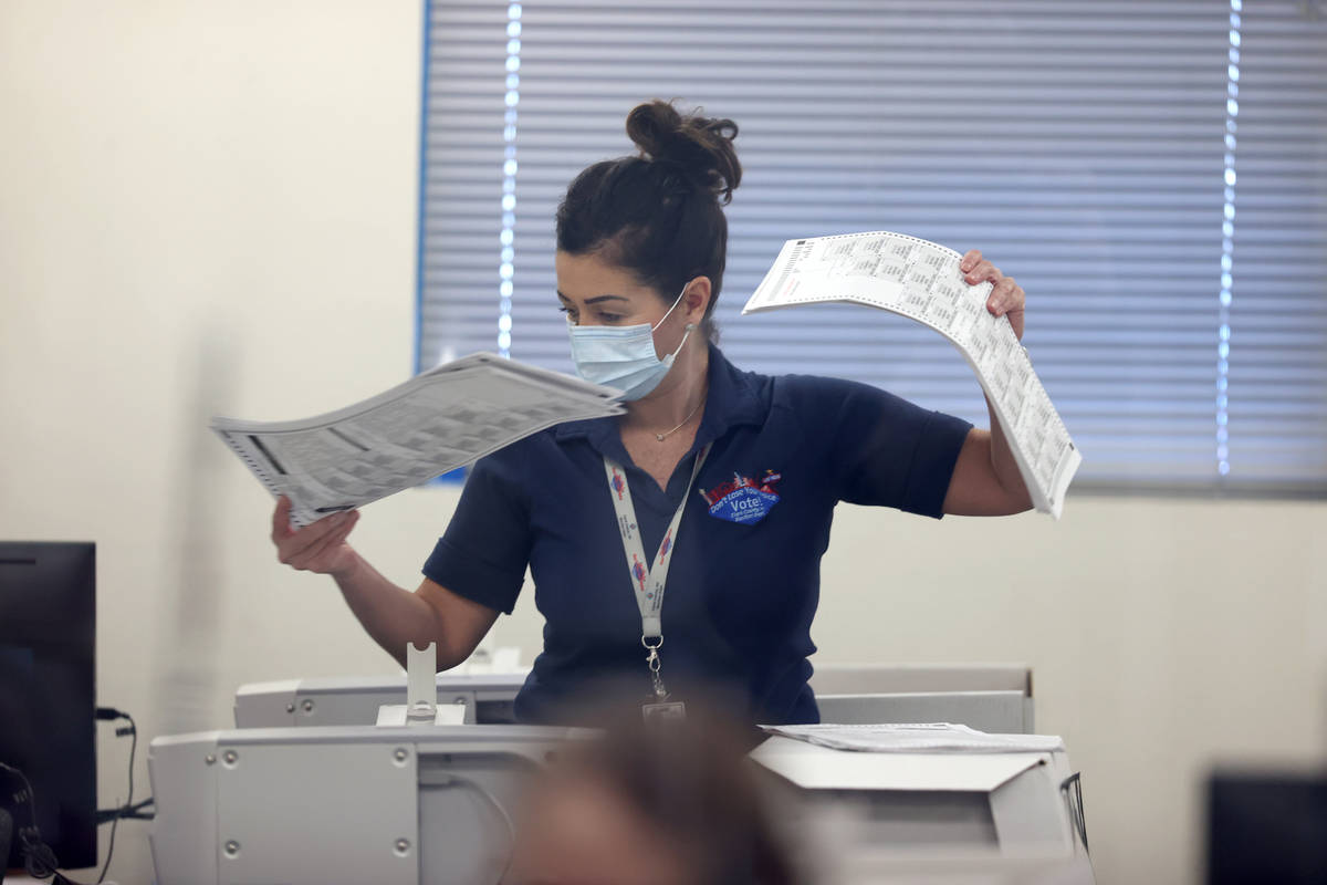 County Election Department staff work on the recount in the Commission District C race between ...