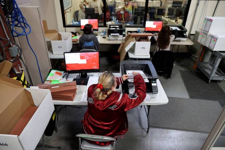 County Election Department staff work on the recount in the Commission District C race between ...