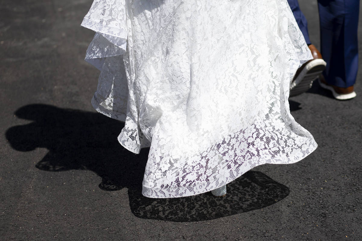 Michael Durham and Khiana Allen, of Texas, walk for photographs after getting married at the Li ...