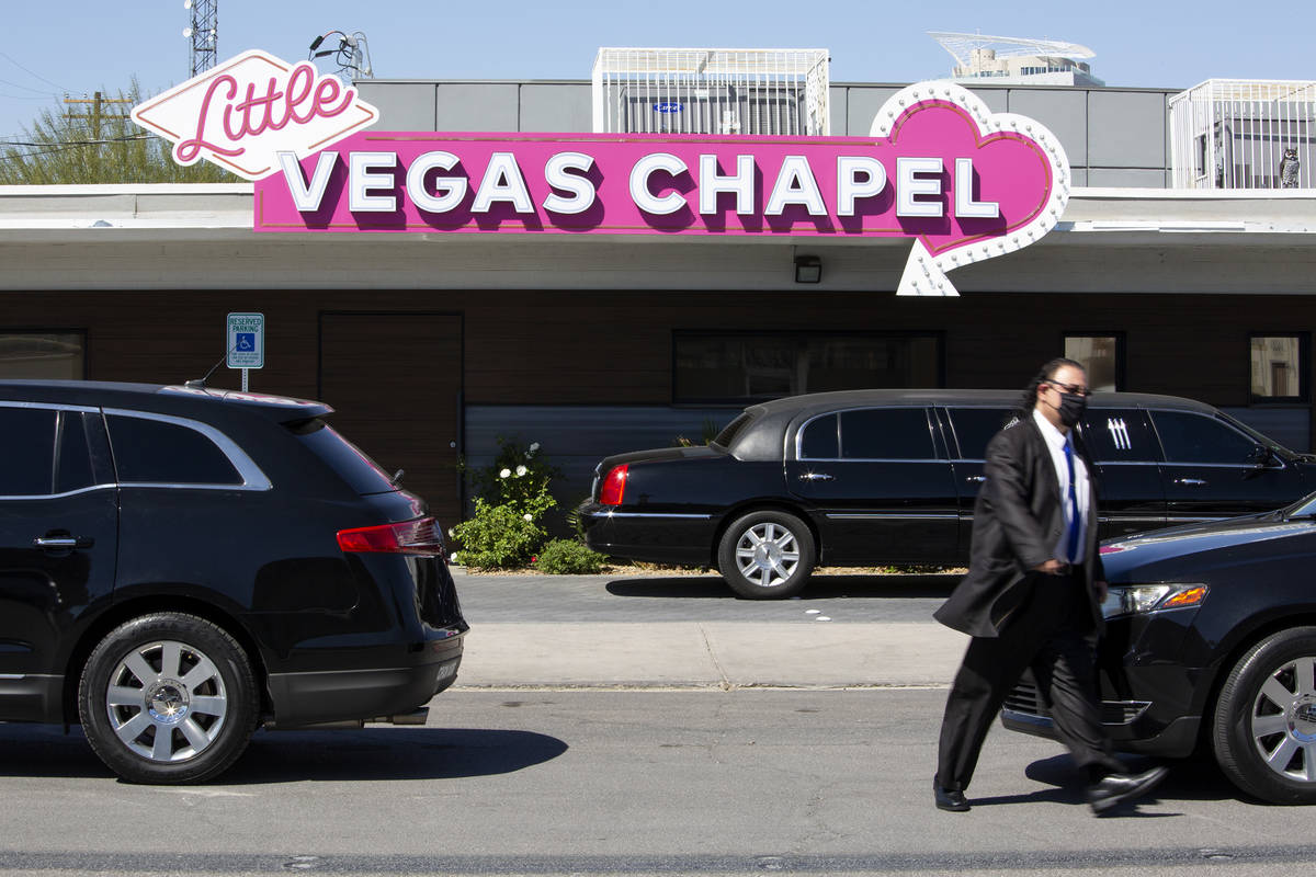 Limousines line up outside the Little Vegas Chapel, where 36 couples were married on Saturday, ...