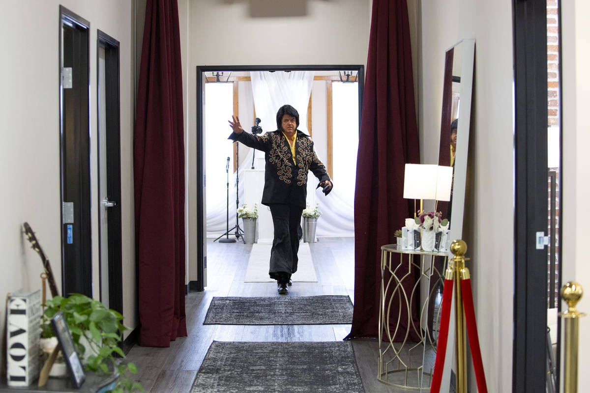 Elvis impersonator Tim Ritchey waves after officiating a wedding at the Little Vegas Chapel on ...