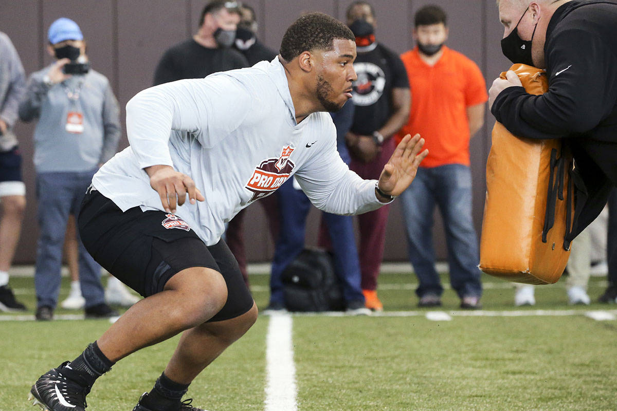 Christian Darrisaw runs a drill Virginia Tech pro day, attended by NFL football scouts, in Blac ...