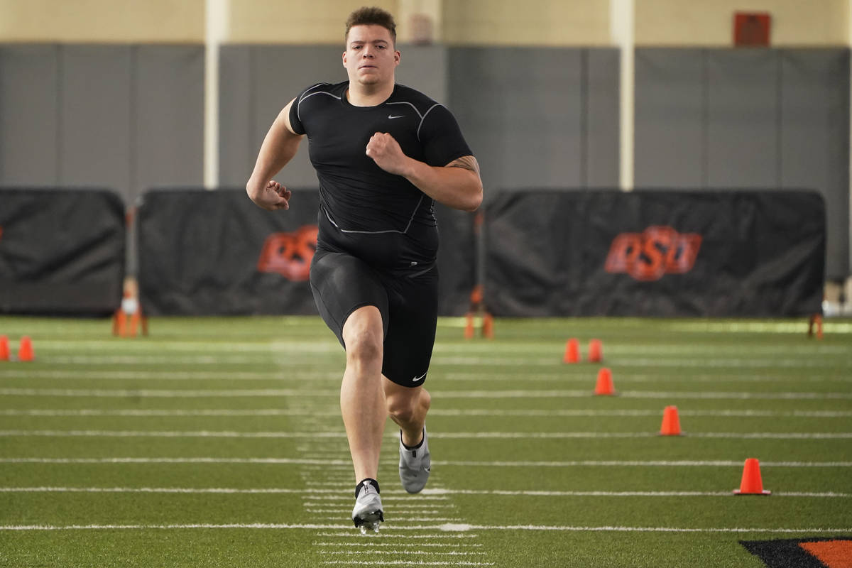Oklahoma state offensive lineman Teven Jenkins runs the 40-yard dash at NFL football pro day, T ...
