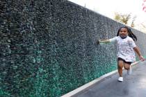 Maia Olivas, 6, of Houston, Texas runs along the water walls at The Park on the Las Vegas Strip ...