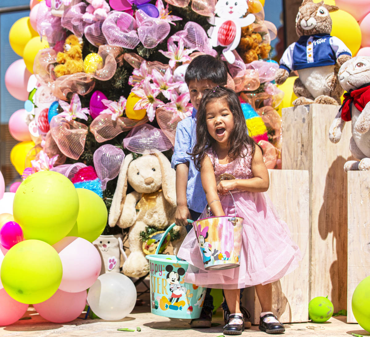 Link, 5, and Calliope Miller, 2, hunt for Easter eggs during an Easter egg hunt and carnival sp ...