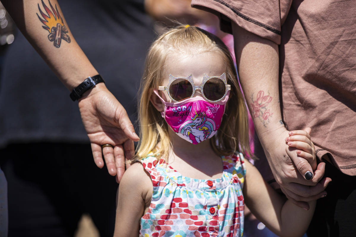 Rowan Wimple, 3, walks with her family during an Easter egg hunt and carnival sponsored by The ...