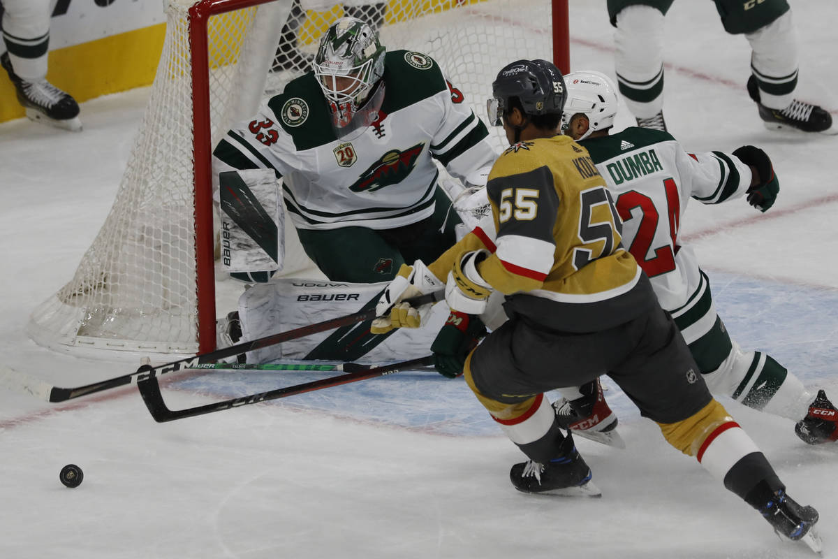 Vegas Golden Knights right wing Keegan Kolesar (55) tries to shoot against Minnesota Wild goalt ...