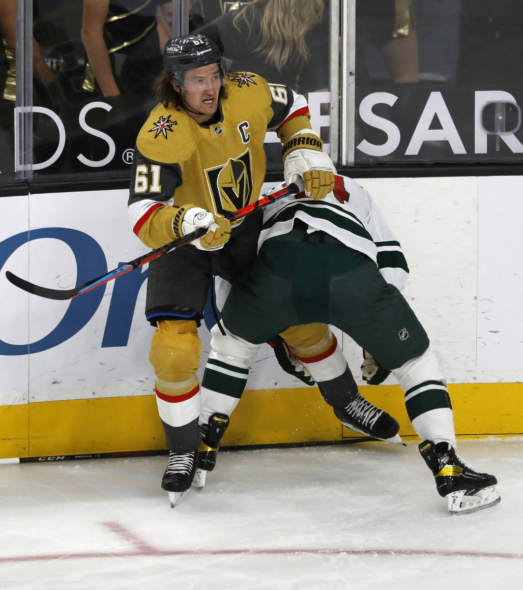 Vegas Golden Knights right wing Mark Stone (61) tangles with Minnesota Wild center Joel Eriksso ...