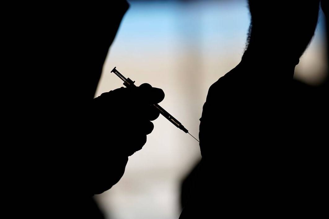 A man receives a COVID-19 vaccine at a vaccination site in Las Vegas in February 2021. (AP Pho ...