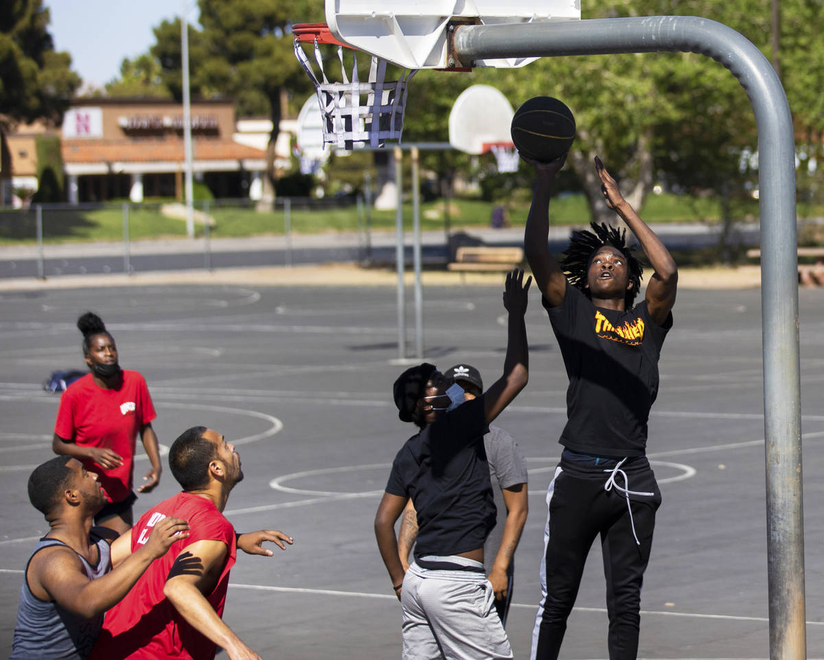 Players play a game of pickup basketball at Sunset Park on Saturday, April 3, 2021, in Las Vega ...
