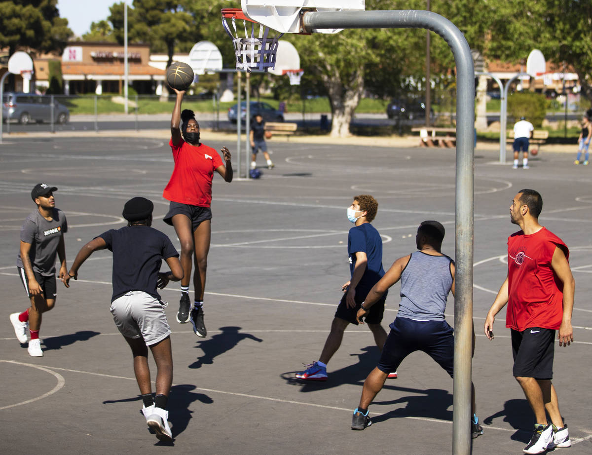 Players play a game of pickup basketball at Sunset Park on Saturday, April 3, 2021, in Las Vega ...