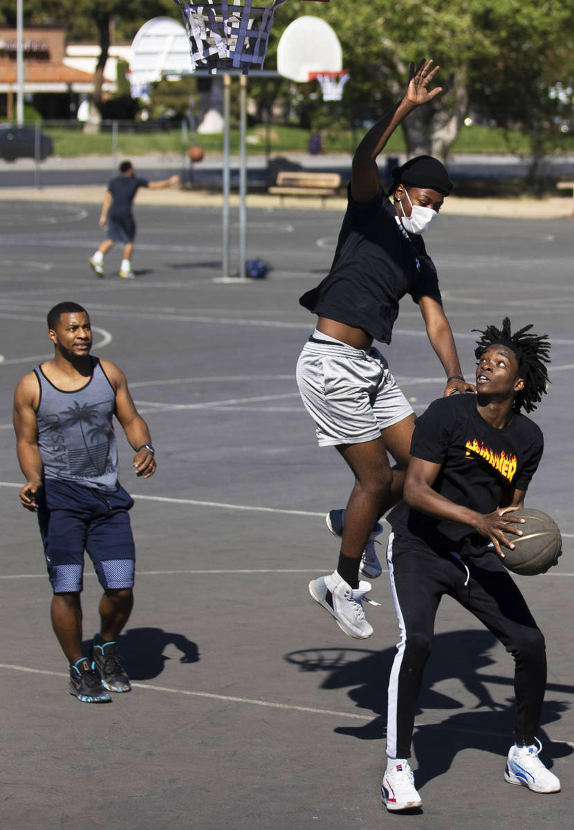 Players play a game of pickup basketball at Sunset Park on Saturday, April 3, 2021, in Las Vega ...