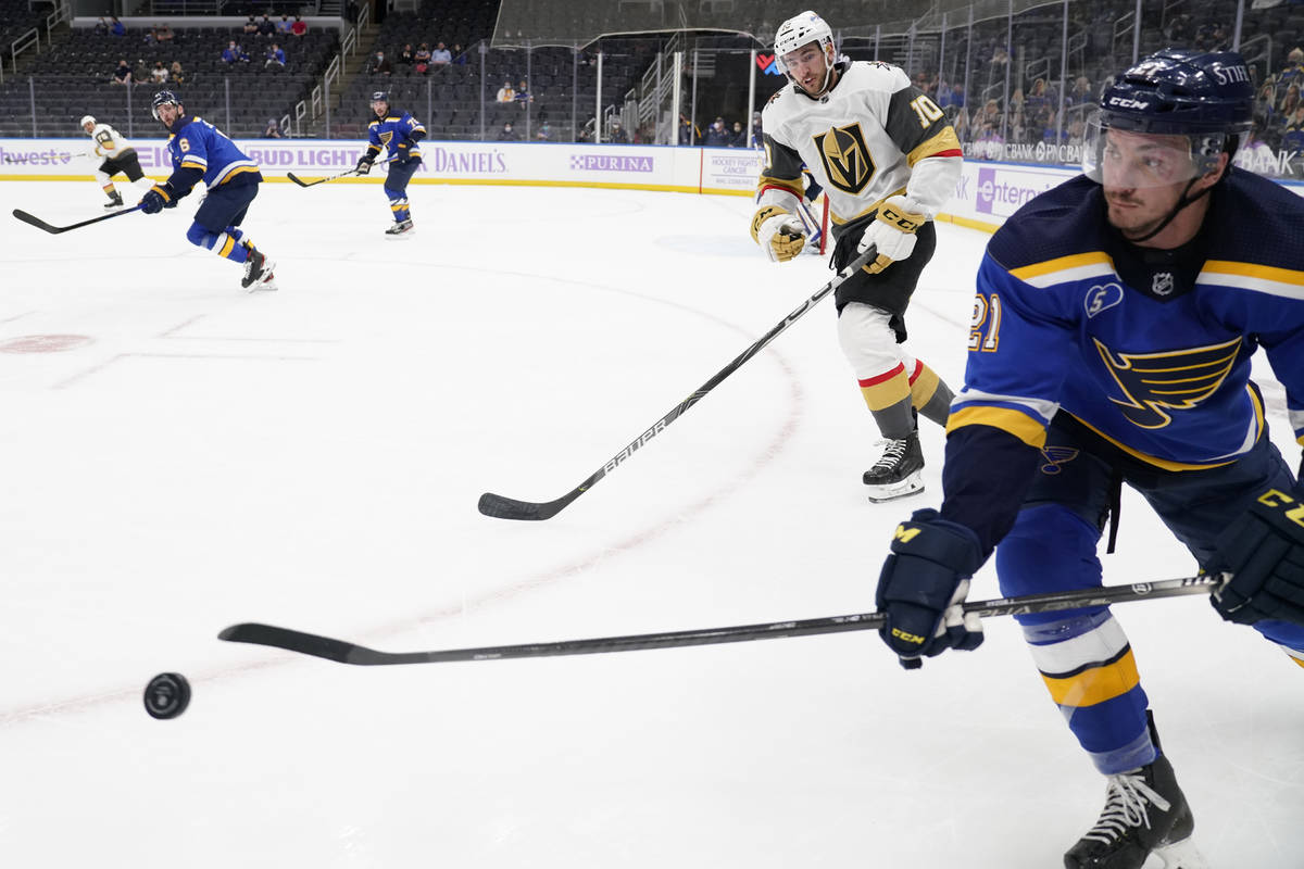 St. Louis Blues' Tyler Bozak, right, passes as Vegas Golden Knights' Nicolas Roy (10) skates by ...