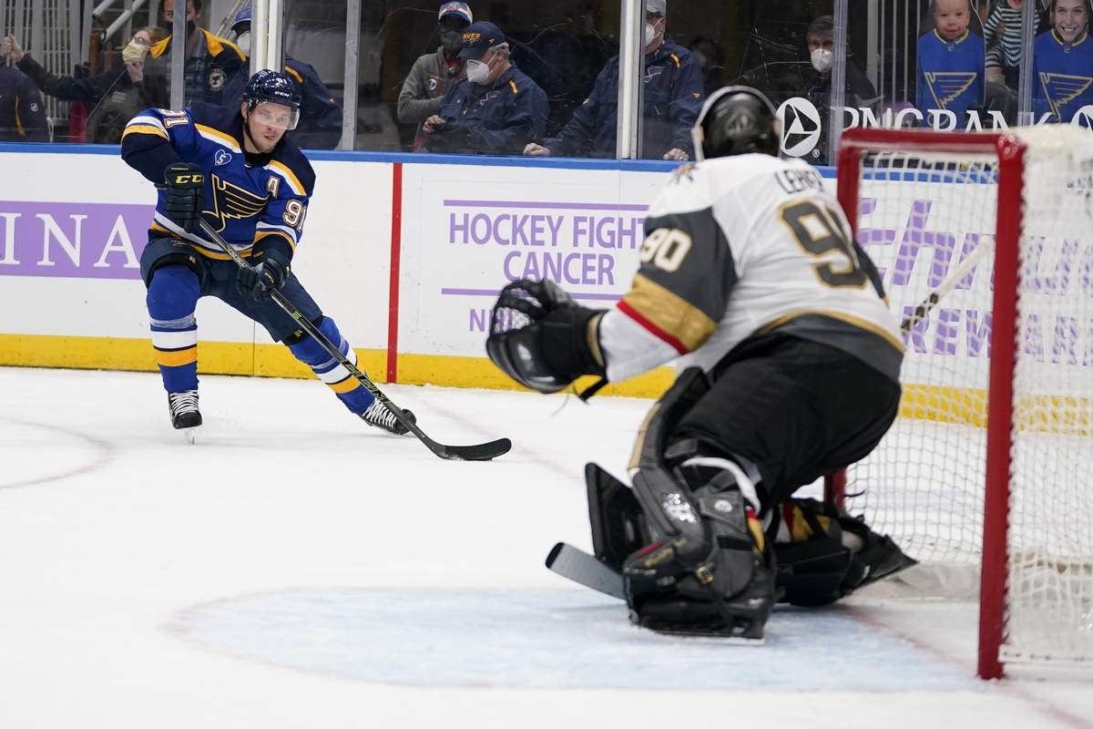 St. Louis Blues' Vladimir Tarasenko, left, looks for an opening past Vegas Golden Knights goalt ...