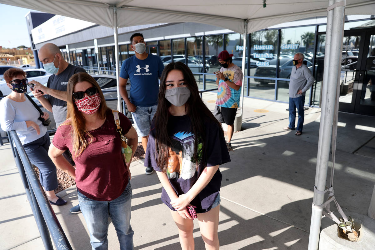 Isabella D'Angelo, 17, lines up for a COVID-19 vaccination with her mother Tracey D'Angelo at t ...