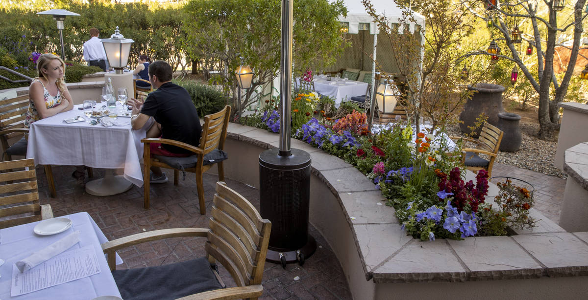 Tory and Troy Dixon eat at the Vintner Grill's outdoor dining area, which has flower gardens, g ...