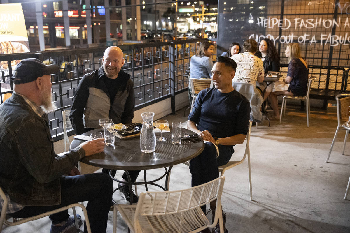 Mike Walton, from left, David Brown and Rich Crithfield dine at Carson Kitchen's outdoor area i ...