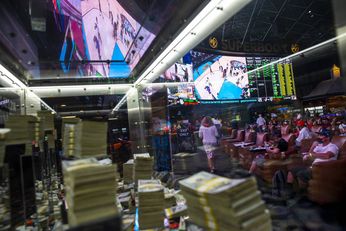 Basketball fans walk to the Westgate sportsbook windows to collect winnings after Baylor defeat ...