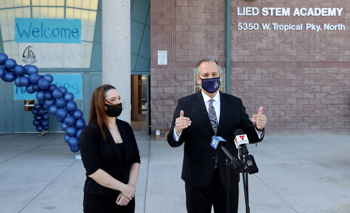 Superintendent Jesus Jara and Trustee Katie Williams talk to the news media after welcoming stu ...