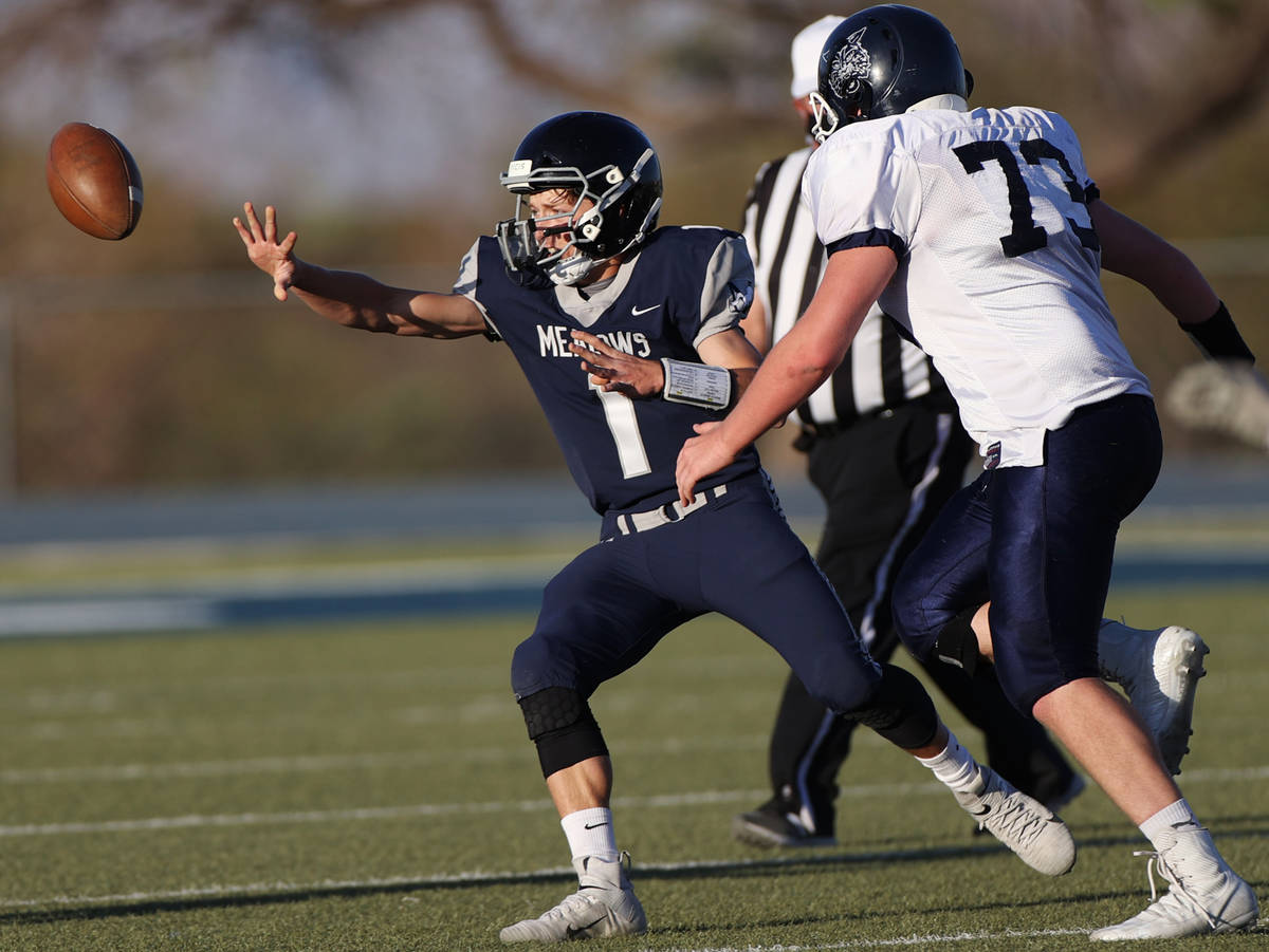 Meadows' Michael Corrigan (1) makes a pass under pressure from White Pine's Zachary Weatherspoo ...