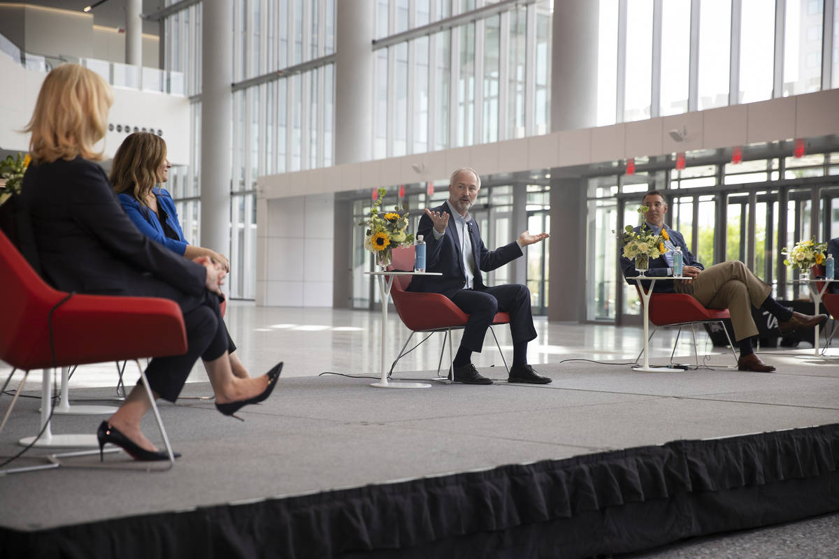 Steve Hill, center, president and CEO of the Las Vegas Convention and Visitors Authority, speak ...