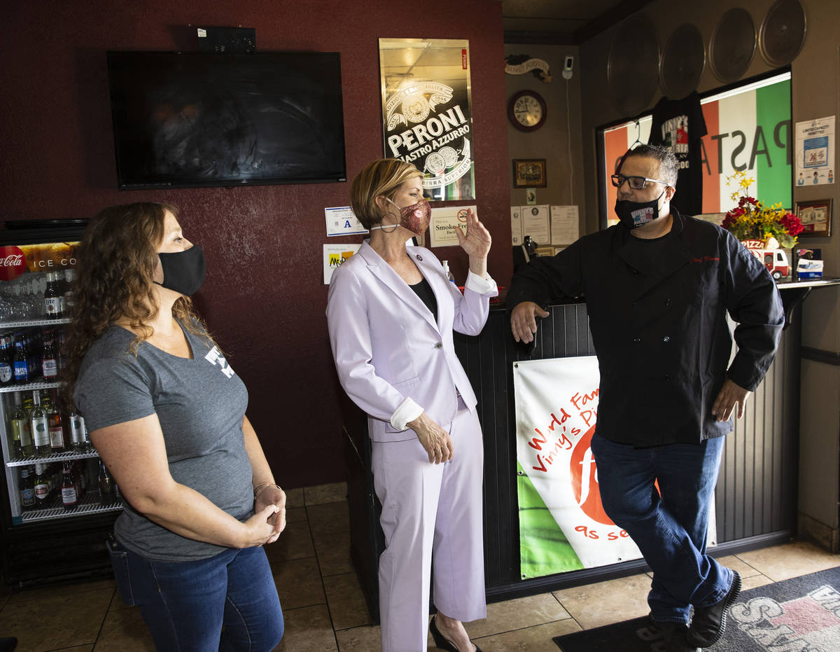 Rep. Susie Lee speaks as Vincenzo Cimino, right, owner of Vinny's Pizzeria, and his wife Tina l ...