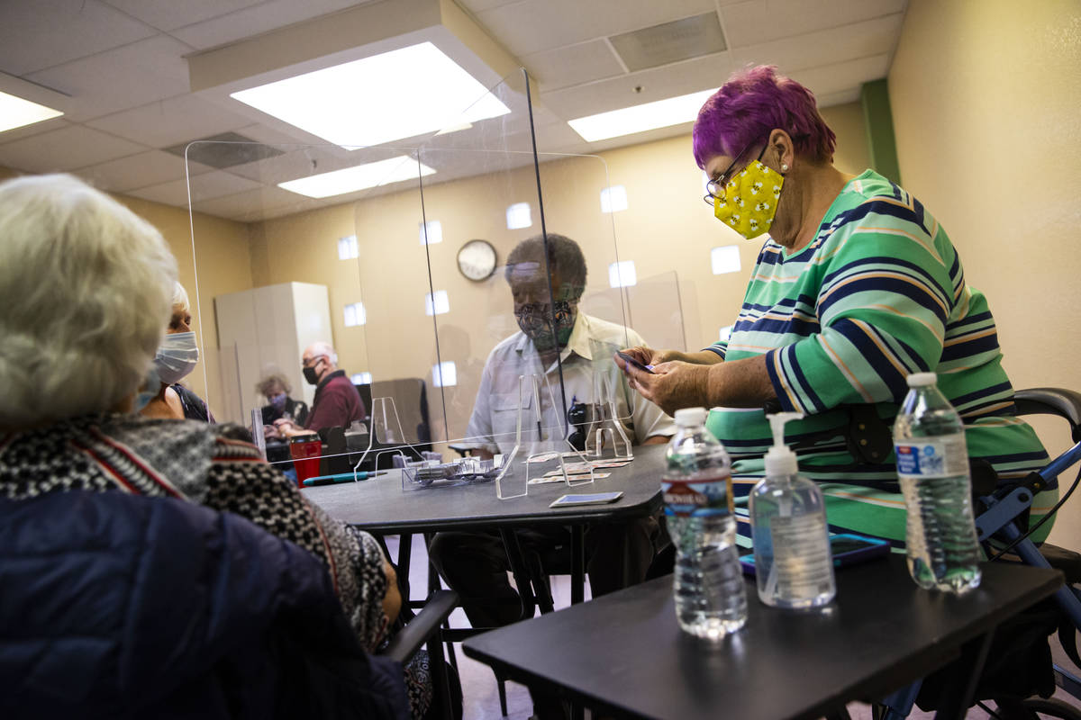 Dotty Ducret, right, and Gordon Dew, center, play the card game canasta at the West Flamingo Se ...