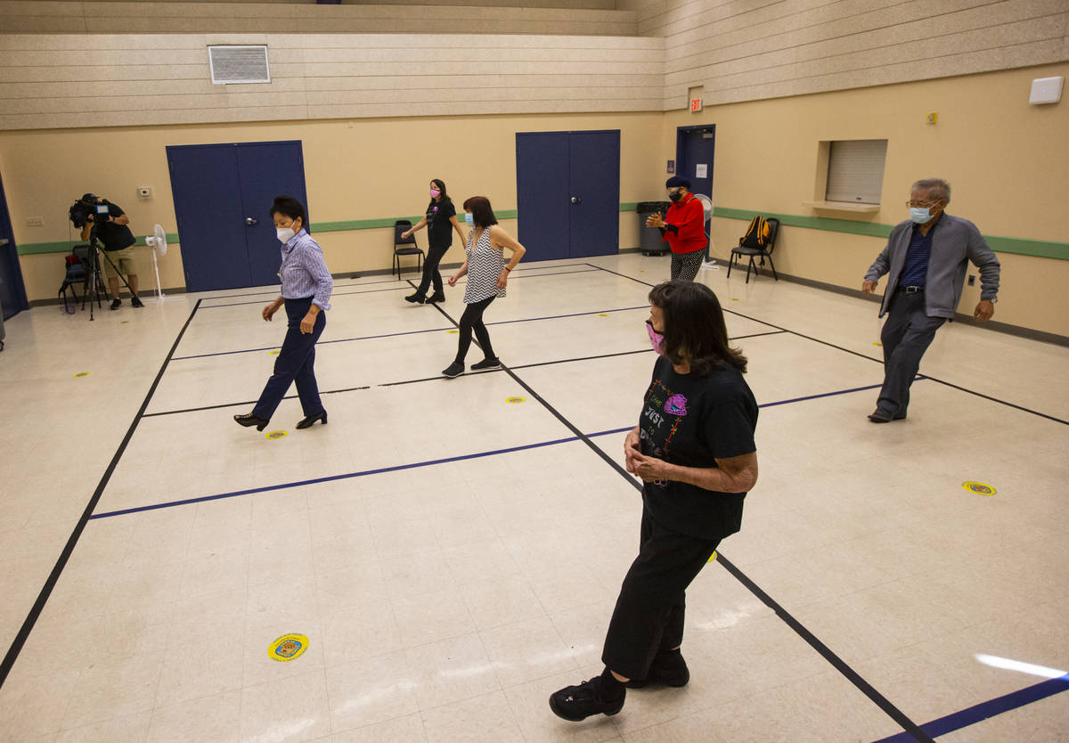 Dance instructor Irma Achey, lower right, leads a line dancing class at the West Flamingo Senio ...