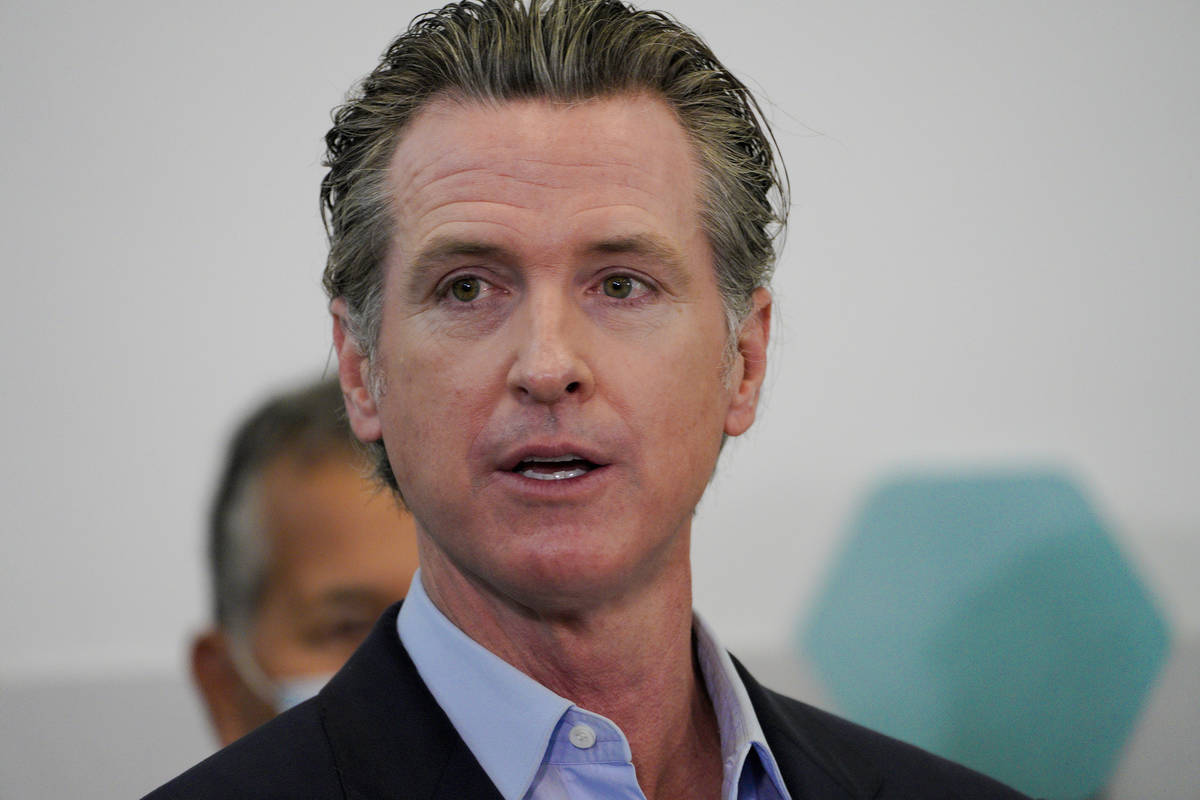 Governor Gavin Newsom speaks with news reporters at Park de la Cruz Recreation Center on Friday ...