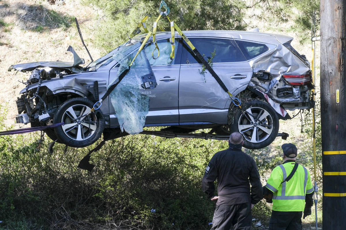 In this Feb. 23, 2021, file photo, a crane is used to lift a vehicle following a rollover accid ...