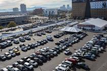 Rows of cars fill surrounding parking lots as crowds of people gather for the opening day of th ...