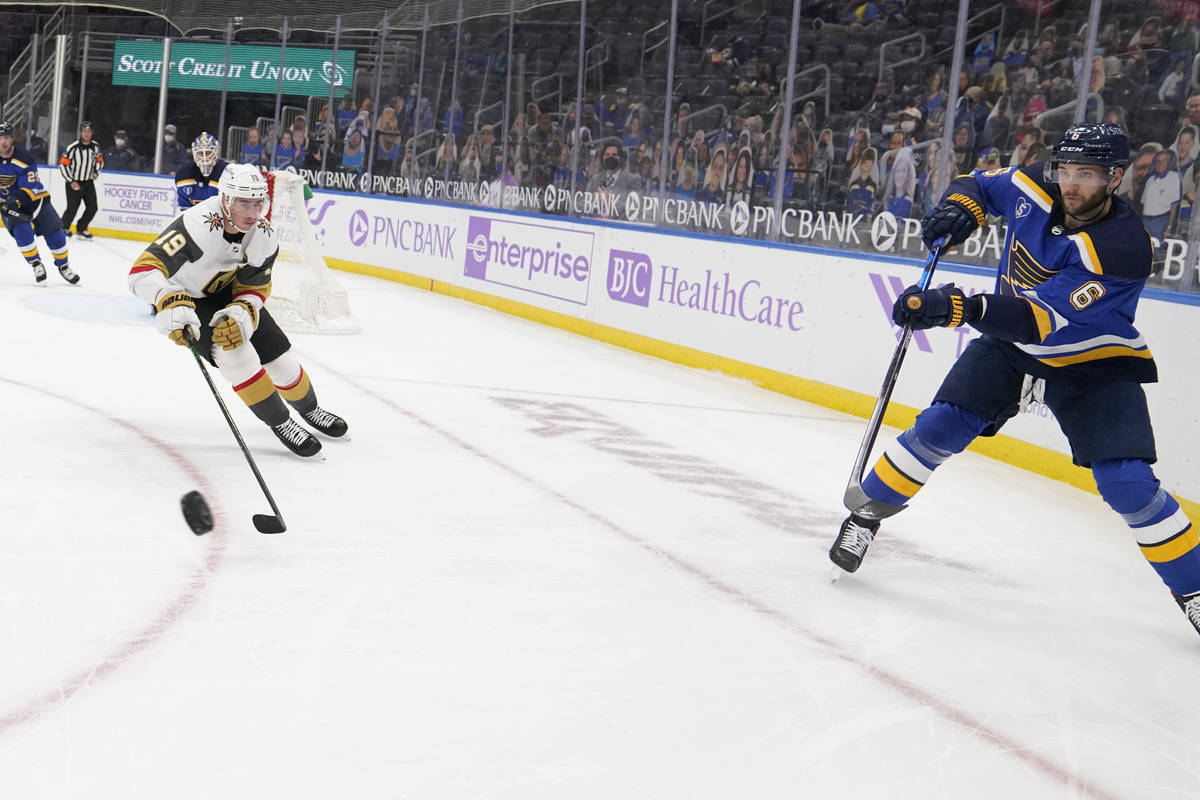 St. Louis Blues' Marco Scandella (6) passes around Vegas Golden Knights' Reilly Smith (19) duri ...