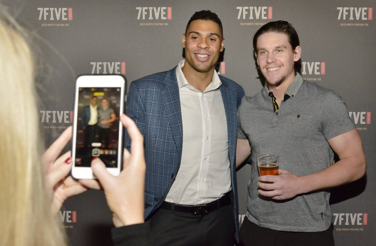 Vegas Golden Knights hockey player Ryan Reaves, left, has his picture taken with teammate Erik ...